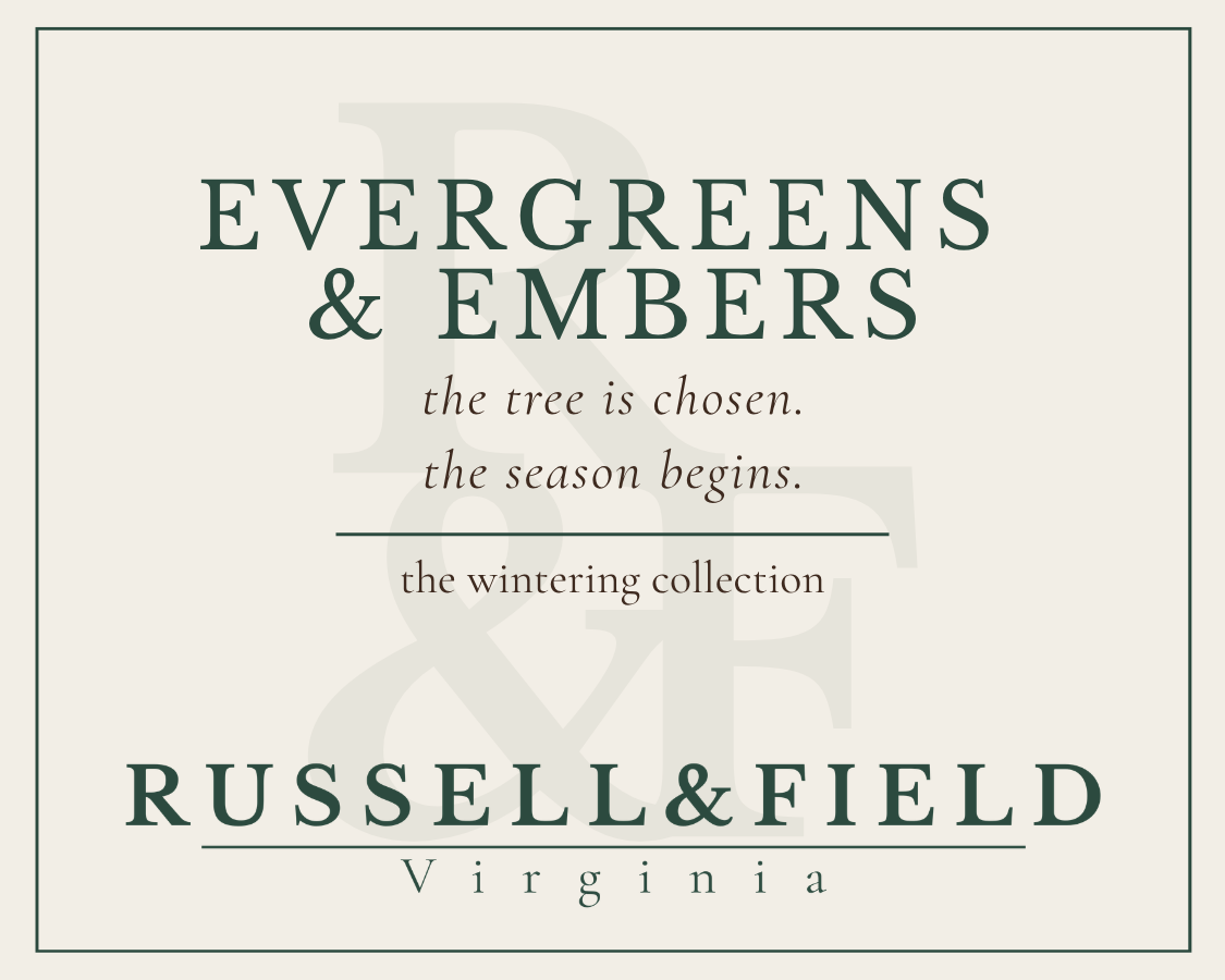 Evergreens and Embers candle label for Russell & Field Virginia, featuring the text 'EVERGREENS & EMBERS' and the line 'the tree is chosen. the season begins."