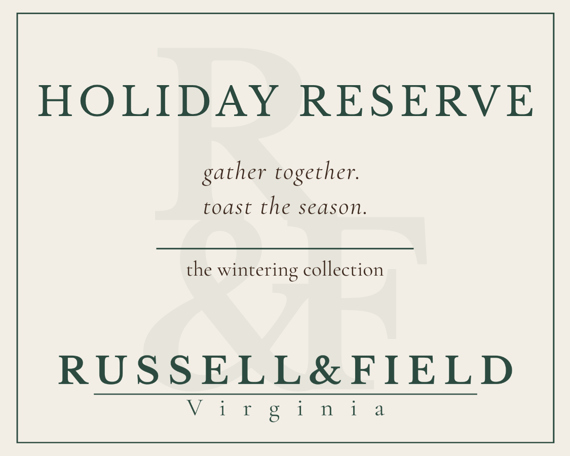 Holiday Reserve candle label for Russell & Field Virginia, featuring the text 'HOLIDAY RESERVE' and the line 'gather together. toast the season.