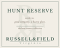 Hunt Reserve candle label for Russell & Field Virginia, featuring the text 'HUNT RESERVE' and the line "settle in. good company, a heavy glass."