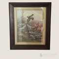 Vintage framed pheasant sporting print featuring three pheasants among weathered wooden fencing, tall autumn grasses, and bare woodland trees, presented with cream matting in a dark carved wood-style frame.