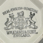 English Ironstone Teapot & Sugar Bowl — W.T. Adams & Sons. Close-up of the maker's mark printed with the text 'REAL ENGLISH IRONSTONE' and 'WM. ADAMS & SONS ENGLAND' around a crest featuring a cat, deer, and lion.