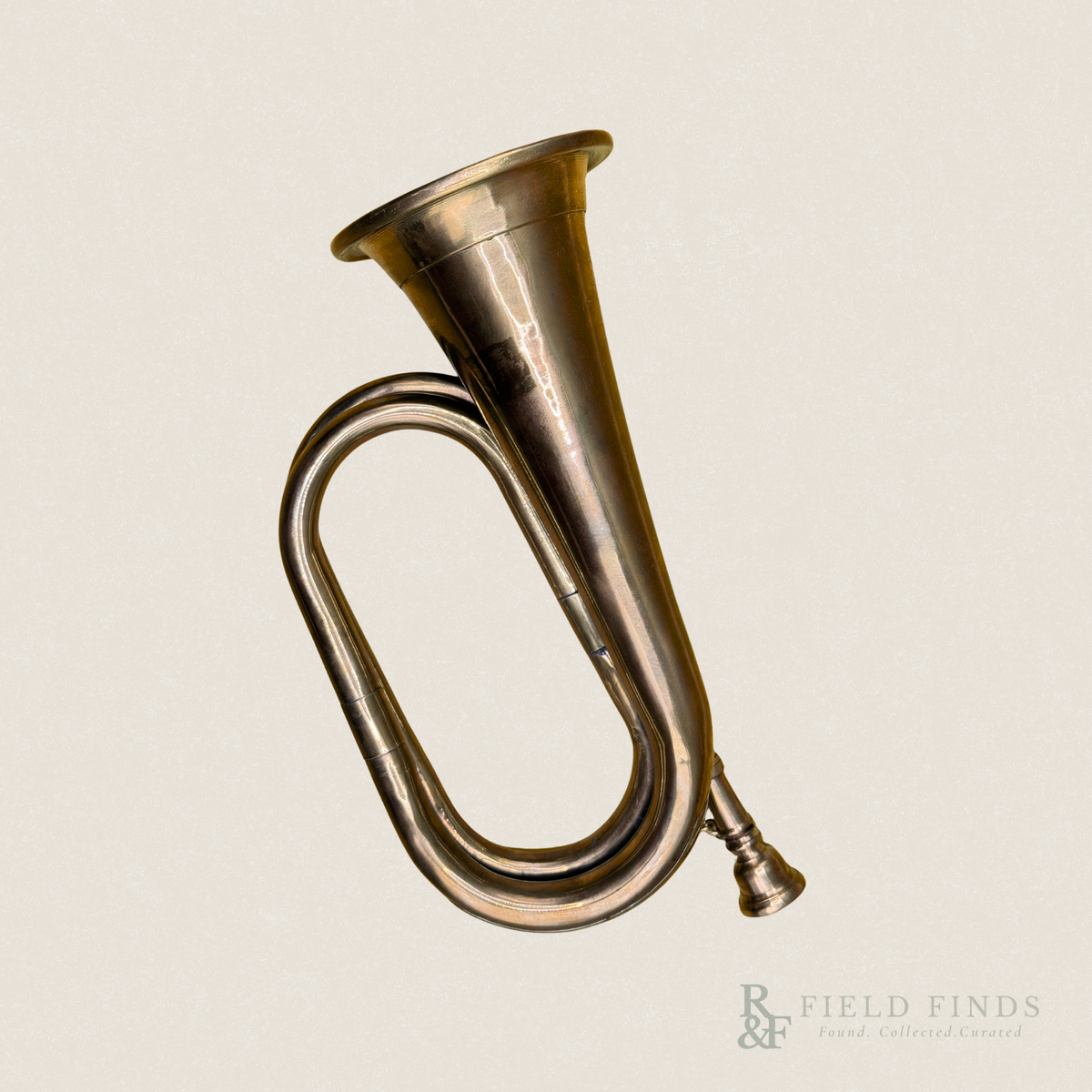 Vintage brass hunting-style horn with a curved tubular body, flared bell, and aged golden brass finish, photographed against a warm ivory background.